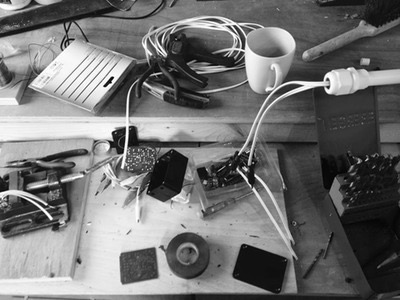 Workshop Bench with wires cup of coffee tools and small electronics